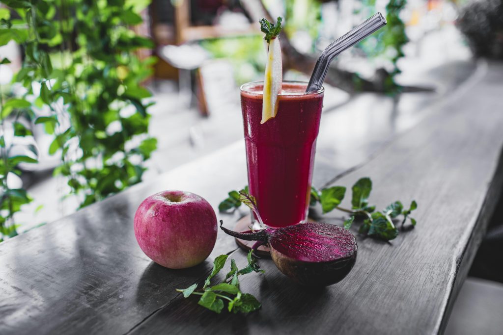 Refreshing beetroot and apple juice garnished with mint leaves, perfect for a healthy detox.