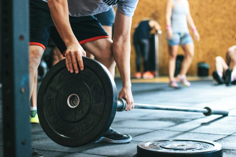 Focused weightlifting session in a gym with diverse athletes participating indoors.